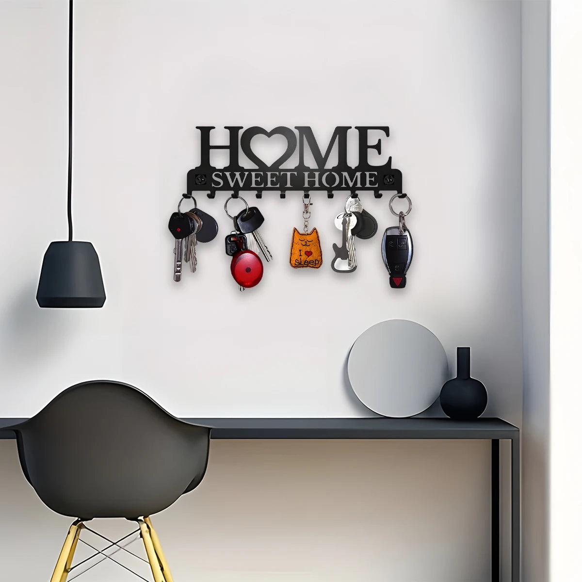 Black metal wall-mounted key holder with hooks, designed for home organization by eprolo, featuring a sleek, modern aesthetic.