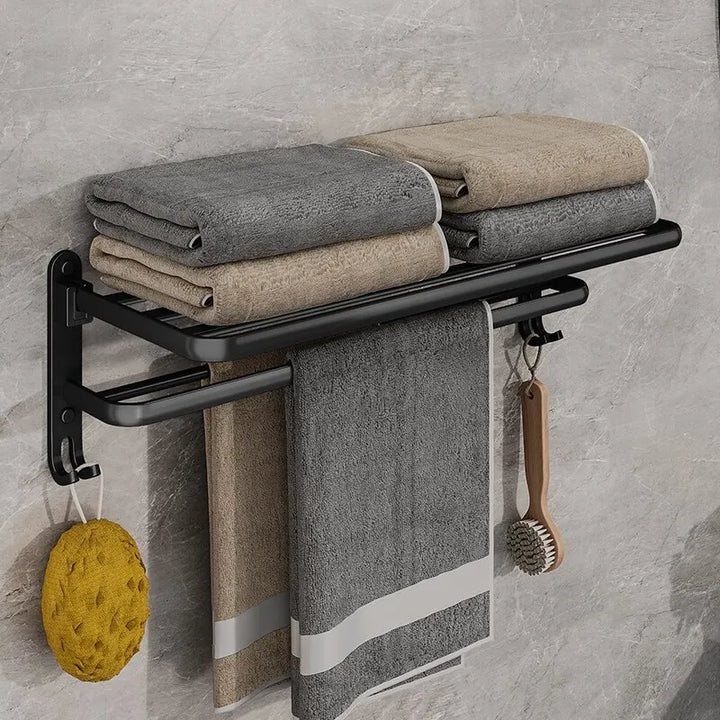 Matte black 50cm folding towel holder with hook, wall mount, by eprolo, shown mounted on a bathroom wall with towels.