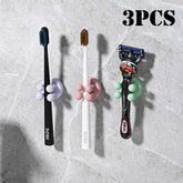 Set of three adhesive silicone toothbrush holders from eprolo, wall-mounted and designed for hanging toothbrushes and small accessories.