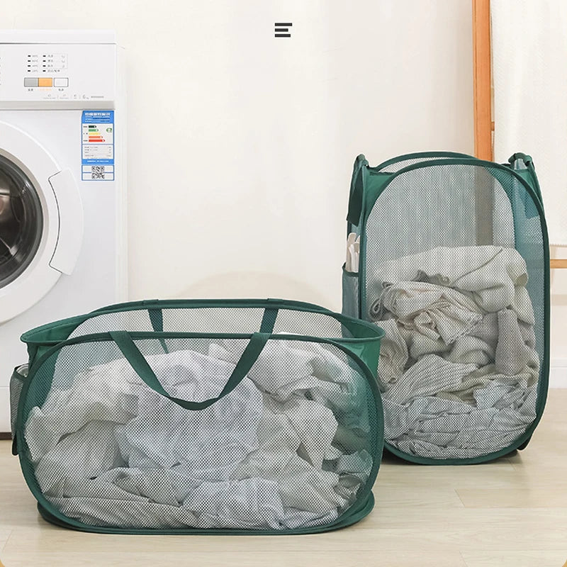 Green mesh laundry hampers filled with clothes beside a washing machine