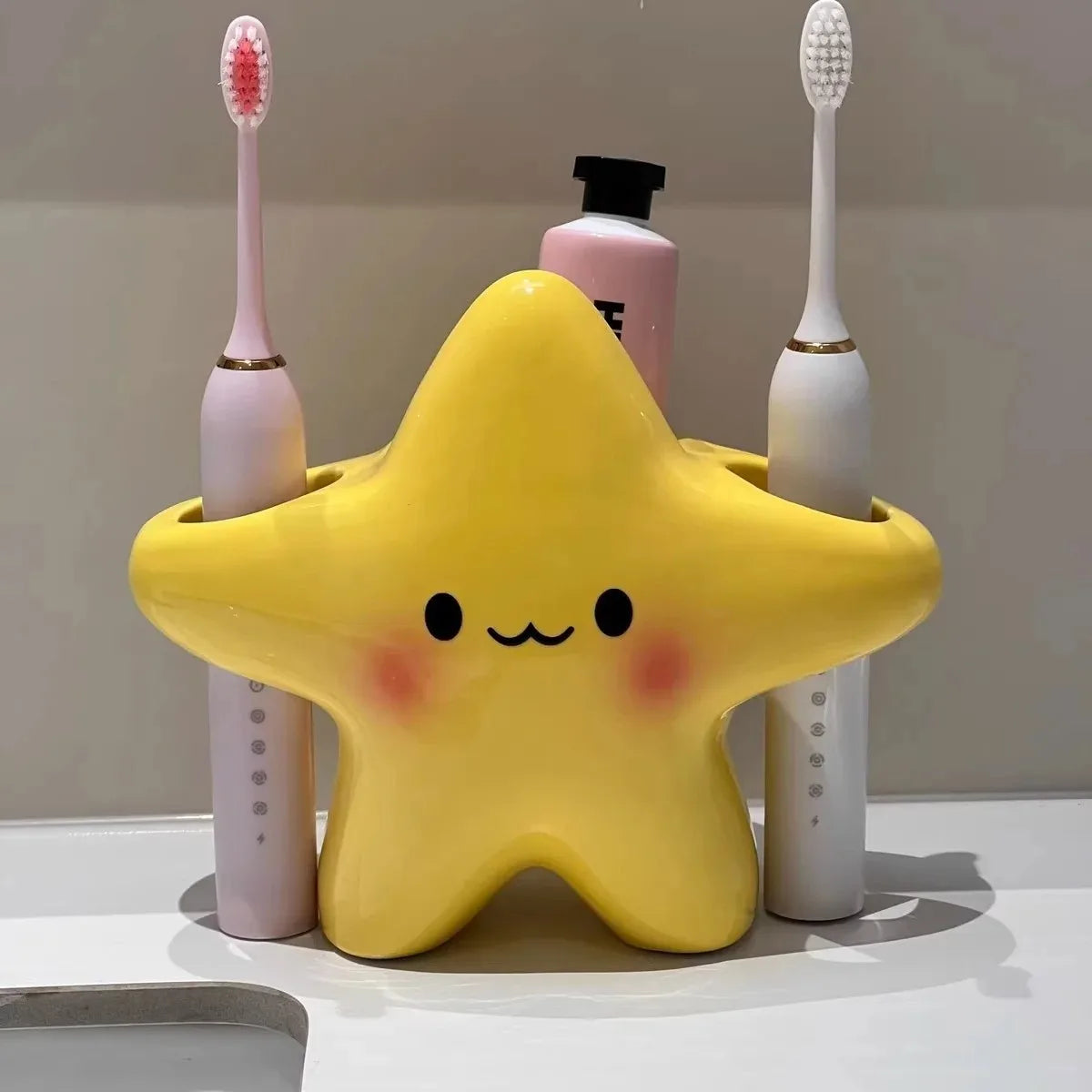 Cute star-shaped toothbrush holder by eprolo, freestanding bathroom organizer with space for toothbrushes and small toiletries.
