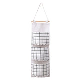 Eprolo dormitory wall hanging storage bag with three pockets, ideal for organizing small items in a home or student room.