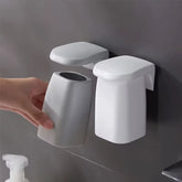 Japanese style minimalist magnetic mouthwash cup set mounted on wall, by eprolo, in a sleek, modern bathroom decor.