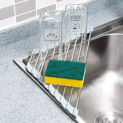 Foldable stainless steel triangle dish rack by eprolo with drainboard, kitchen sink corner sponge organizer in a modern kitchen.