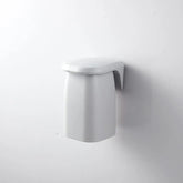 Japanese style minimalist magnetic mouthwash cup wall mount by eprolo, showing a sleek, white ceramic cup attached to a modern wall bracket.